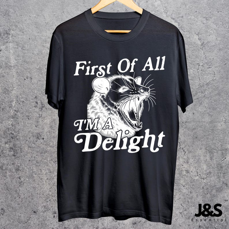 May include: Black t-shirt with a white graphic of an animal with the text "First Of All I'M A Delight".