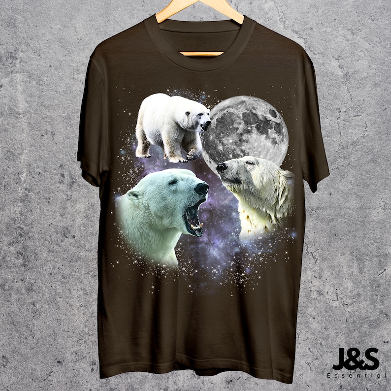 May include: Brown t-shirt featuring a graphic design of three polar bears with a full moon and a starry background. The polar bears are in different poses, with one yawning. The text "J&S Essential" is at the bottom right.