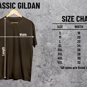 May include: A brown t-shirt hanging on a wooden hanger, with a size chart to the right. The size chart lists sizes S through 5XL, with corresponding width and length measurements in inches. The text "CLASSIC GILDAN" is at the top.