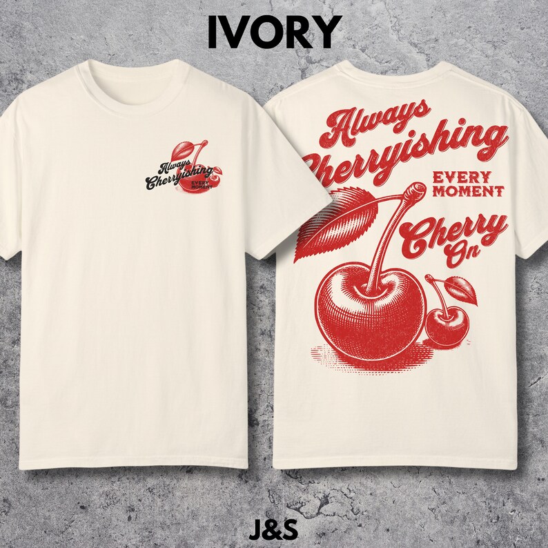 May include: Ivory t-shirt with a red cherry graphic on the back. The graphic says "Always Cherryishing Every Moment Cherry On".