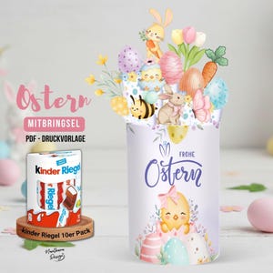 May include: A decorative Easter-themed paper craft with the word "Ostern" and a package of Kinder Riegel chocolate. The craft features illustrations of Easter eggs, bunnies, a chick, and flowers. The text "MITBRINGSEL" and "PDF - DRUCKVORLAGE" are also visible.