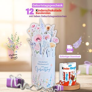 Könnte beinhalten: Ein weißer Papierzylinder mit floralem Design und dem Text "Herzlichen Glückwunsch zum Geburtstag!" hält Papierblumen. Das Bild enthält eine Schachtel Kinder Riegel Schokolade und ein verpacktes Geschenk. Der Text oben lautet "Geburtstagsgeschenk 12 Kinderschokolade Banderolen".