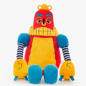 May include: A colourful plush robot toy. The robot has a red head with yellow details, blue arms, and a yellow torso. The arms have blue and white striped sleeves. The robot's feet are blue and yellow. A fun toy for children.