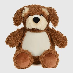 May include: A brown, curly-furred dog plush toy. It has a cream-coloured muzzle and belly, and a black nose. The toy is in a sitting position, with its paws and ears visible. A soft, cuddly stuffed animal.