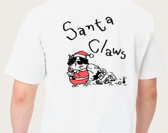 May include: White t-shirt with a graphic of a cat dressed as Santa Claus wearing sunglasses, with the text "Santa Claws" above the graphic. The cat is wearing a red Santa suit and hat, and is carrying a bag of gifts.