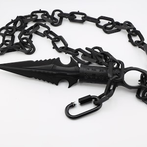 May include: A black chain with a black metal spike attached to one end. The chain has a black metal clasp.