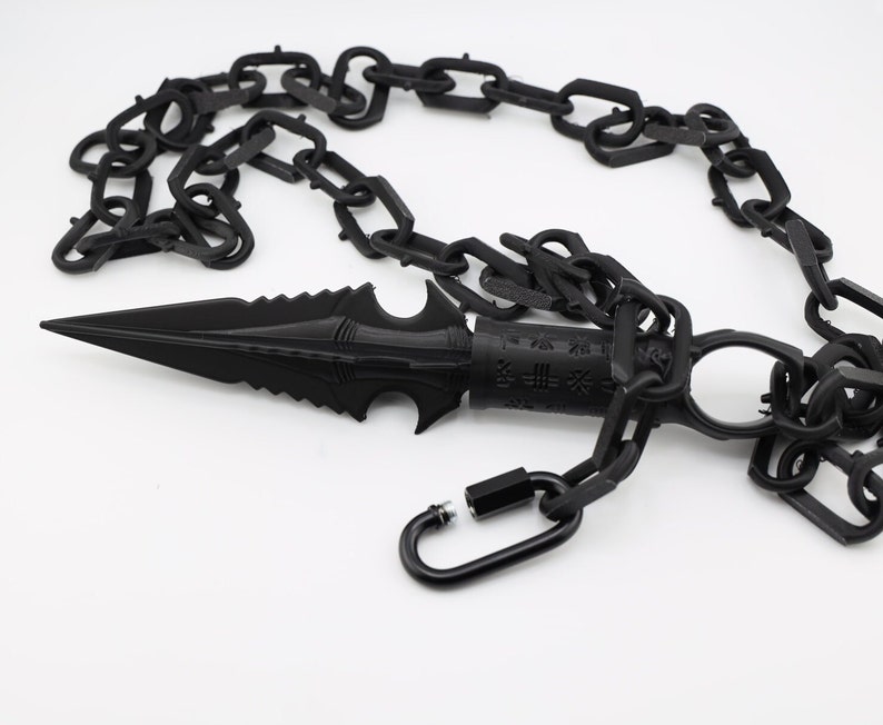 May include: A black chain with a black metal spike attached to one end. The chain has a black metal clasp.