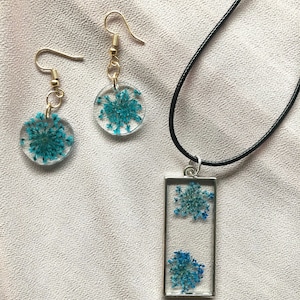 Matching pressed flower blue dyed cow parsley resin silver and gold earrings and necklace set