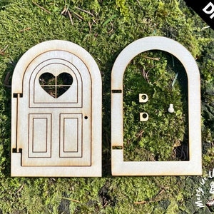May include: DIY kit for a wooden fairy door with a heart-shaped window and a simple design. The door is unfinished and ready to be painted or stained.