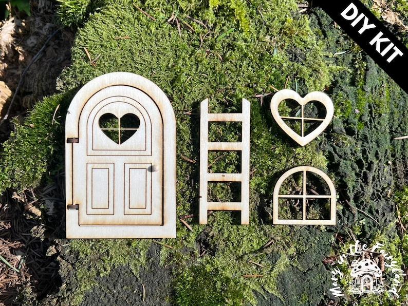 May include: DIY kit for a fairy door, featuring a wooden door with a heart-shaped window, a ladder, a heart-shaped window, and a square window.