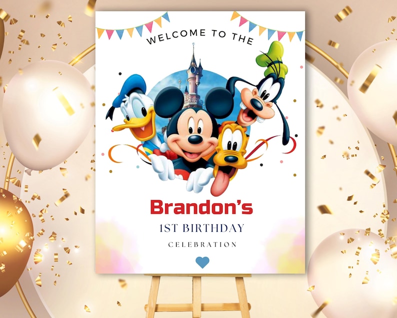 May include: A rectangular birthday sign featuring Mickey Mouse, Donald Duck, Goofy, and Pluto with a castle background. The text reads WELCOME TO THE, Brandon's, 1ST BIRTHDAY, CELEBRATION, with colorful bunting at the top and a blue heart at the bottom.