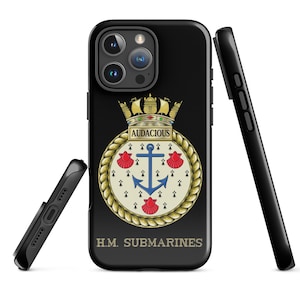 Puede incluir: Funda de teléfono negra con un emblema dorado y crema que presenta un ancla, una corona y la palabra "Audacious". También se muestra el texto "H.M. Submarines". También se ven dos fundas de teléfono negras adicionales.