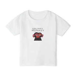 May include: White t-shirt with a cartoon monkey with red cheeks and the text "GRUMPY MONKEY" printed on the front.