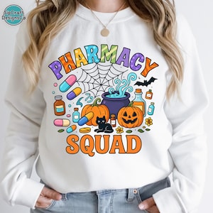 May include: White sweatshirt with a colorful "PHARMACY SQUAD" graphic. The design includes pumpkins, pills, a black cat, and a spiderweb, perfect for Halloween. The text is in orange, purple, and blue.