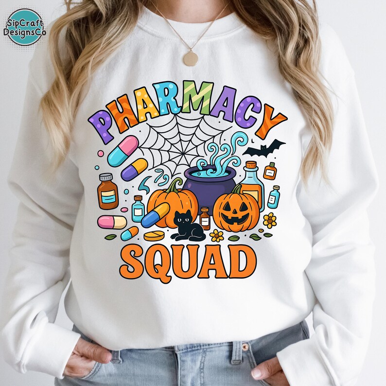 May include: White sweatshirt with a colorful "PHARMACY SQUAD" graphic. The design includes pumpkins, pills, a black cat, and a spiderweb, perfect for Halloween. The text is in orange, purple, and blue.