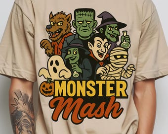 May include: Beige t-shirt featuring a colorful cartoon graphic of Halloween monsters, including a werewolf, Frankenstein's monster, a witch, Dracula, a mummy, and a ghost. The text "MONSTER Mash" is displayed in yellow and orange.