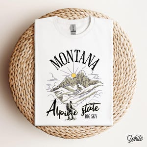 Folded Gildan 64000 Montana hiking tee with nature-inspired graphic, soft cotton fabric