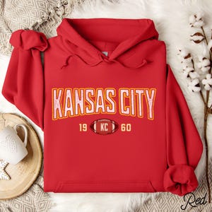 Varsity-style Chiefs hoodie for Kansas City football fans. Perfect for tailgates, Sunday football, or everyday wear. A cozy sweatshirt designed for football fanatics, showcasing Chiefs fandom and making a great fan gift.