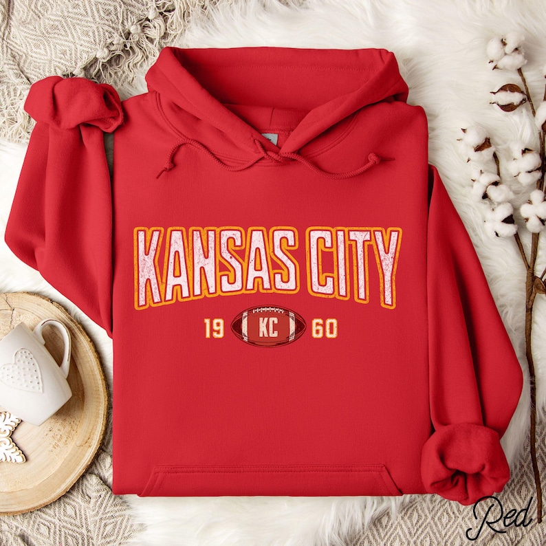 Varsity-style Chiefs hoodie for Kansas City football fans. Perfect for tailgates, Sunday football, or everyday wear. A cozy sweatshirt designed for football fanatics, showcasing Chiefs fandom and making a great fan gift.
