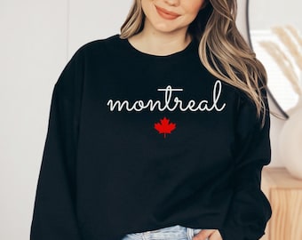 May include: Black sweatshirt with white text that says "montreal" and a red maple leaf.
