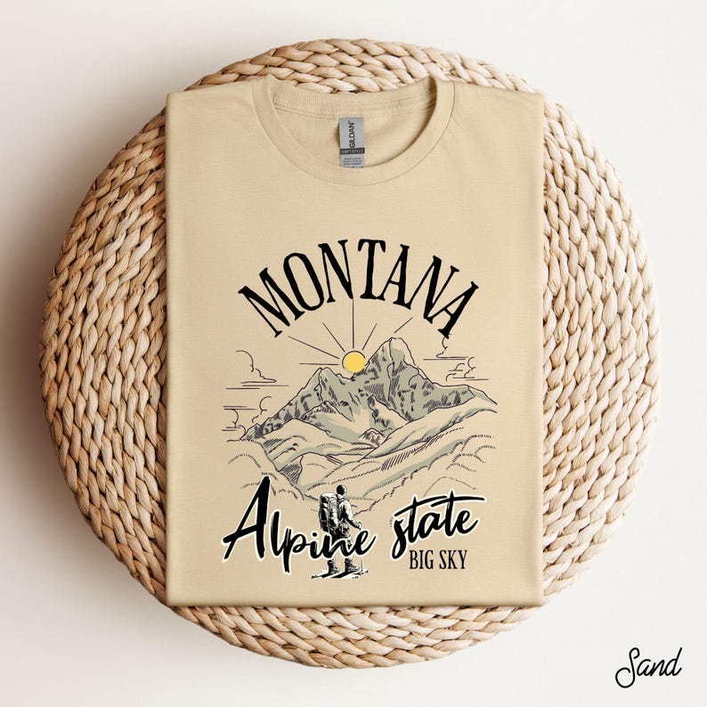 Folded Gildan 64000 Montana hiking tee with nature-inspired graphic, soft cotton fabric