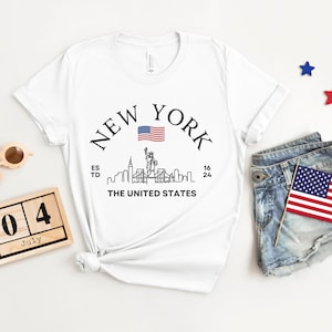 New York Skyline T-Shirt, US Flag Shirt, NYC Skyline Tee, Patriotic NYC Shirt, American Flag Apparel, NYC Skyline Graphic Tee, Statue of Liberty Shirt, NYC Landscape Shirt, Empire State Shirt, NYC Flag Tee, New York City Graphic Tee,