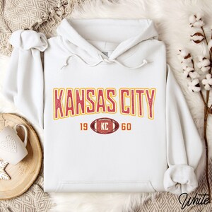 Varsity-style Chiefs hoodie for Kansas City football fans. Perfect for tailgates, Sunday football, or everyday wear. A cozy sweatshirt designed for football fanatics, showcasing Chiefs fandom and making a great fan gift.