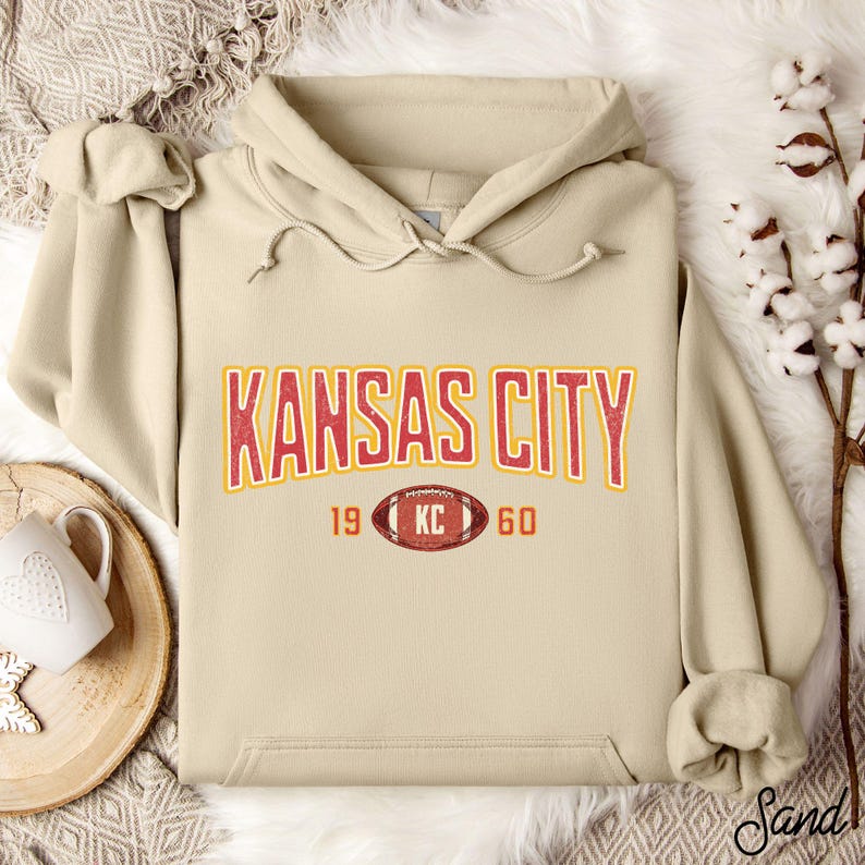 Varsity-style Chiefs hoodie for Kansas City football fans. Perfect for tailgates, Sunday football, or everyday wear. A cozy sweatshirt designed for football fanatics, showcasing Chiefs fandom and making a great fan gift.