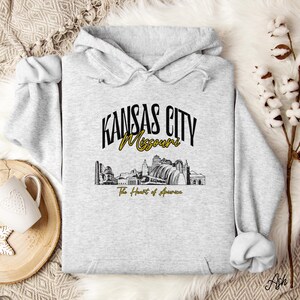 Retro oversized Kansas City skyline Hoodie with vintage cityscape design. Unisex hooded sweatshirt perfect for Kansas City fans and Missouri State lovers. Unique varsity-style Kansas City fan shirt with bold city skyline graphic.
