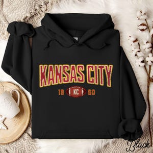 Varsity-style Chiefs hoodie for Kansas City football fans. Perfect for tailgates, Sunday football, or everyday wear. A cozy sweatshirt designed for football fanatics, showcasing Chiefs fandom and making a great fan gift.