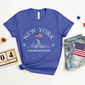 New York Skyline T-Shirt, US Flag Shirt, NYC Skyline Tee, Patriotic NYC Shirt, American Flag Apparel, NYC Skyline Graphic Tee, Statue of Liberty Shirt, NYC Landscape Shirt, Empire State Shirt, NYC Flag Tee, New York City Graphic Tee,