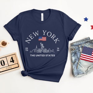 New York Skyline T-Shirt, US Flag Shirt, NYC Skyline Tee, Patriotic NYC Shirt, American Flag Apparel, NYC Skyline Graphic Tee, Statue of Liberty Shirt, NYC Landscape Shirt, Empire State Shirt, NYC Flag Tee, New York City Graphic Tee,