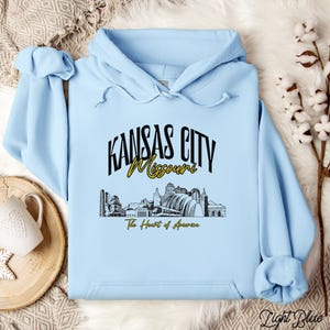 Retro oversized Kansas City skyline Hoodie with vintage cityscape design. Unisex hooded sweatshirt perfect for Kansas City fans and Missouri State lovers. Unique varsity-style Kansas City fan shirt with bold city skyline graphic.