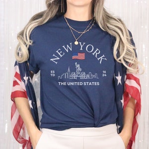 New York Skyline T-Shirt, US Flag Shirt, NYC Skyline Tee, Patriotic NYC Shirt, American Flag Apparel, NYC Skyline Graphic Tee, Statue of Liberty Shirt, NYC Landscape Shirt, Empire State Shirt, NYC Flag Tee, New York City Graphic Tee,