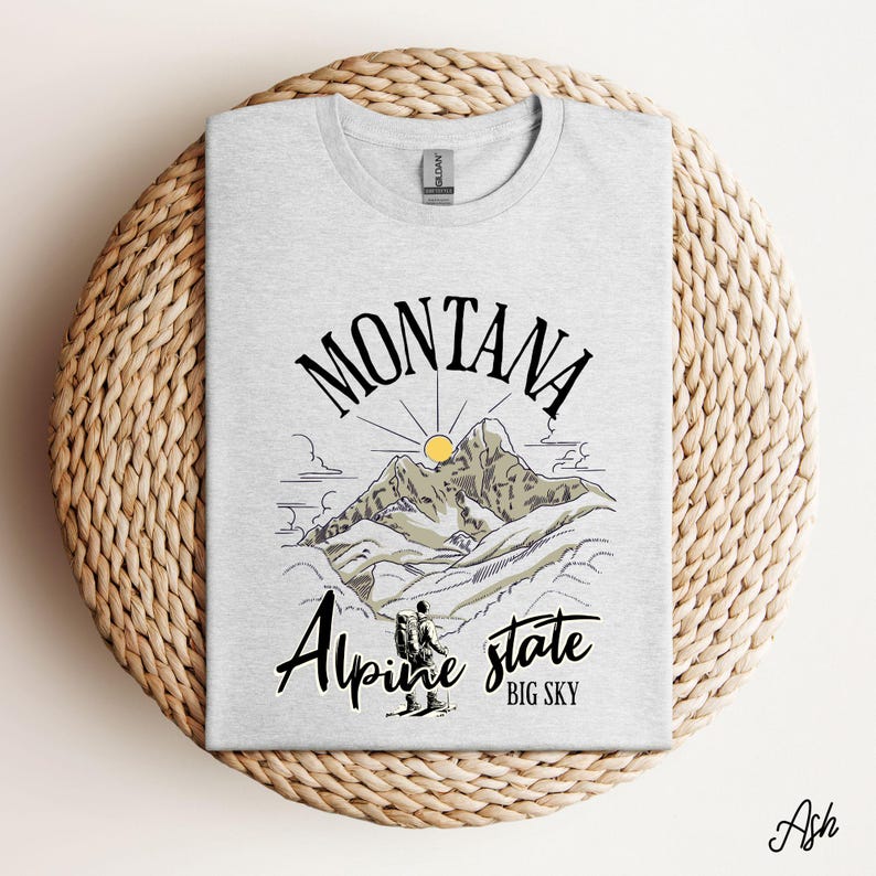 Folded Gildan 64000 Montana hiking tee with nature-inspired graphic, soft cotton fabric