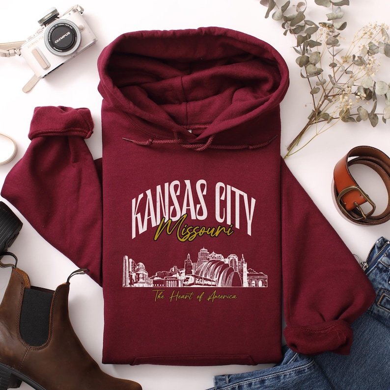 Retro oversized Kansas City skyline Hoodie with vintage cityscape design. Unisex hooded sweatshirt perfect for Kansas City fans and Missouri State lovers. Unique varsity-style Kansas City fan shirt with bold city skyline graphic.