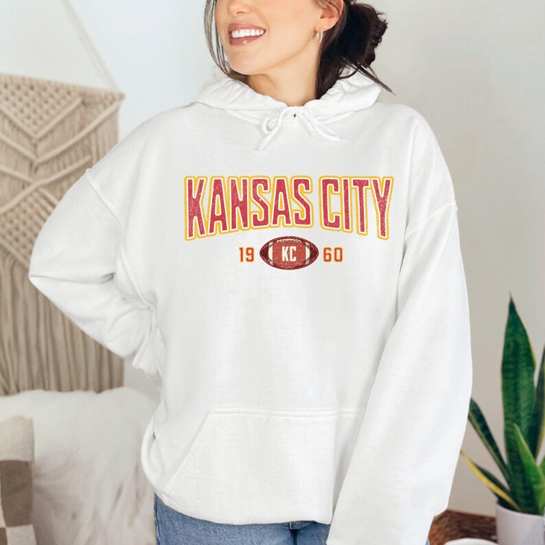 Varsity-style Chiefs hoodie for Kansas City football fans. Perfect for tailgates, Sunday football, or everyday wear. A cozy sweatshirt designed for football fanatics, showcasing Chiefs fandom and making a great fan gift.
