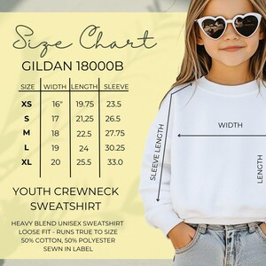 May include: A white youth crewneck sweatshirt with a size chart. The chart shows measurements for sizes XS to XL, with widths ranging from 40.6 cm to 50.8 cm, lengths from 50.2 cm to 64.8 cm, and sleeve lengths from 59.7 cm to 83.8 cm. The sweatshirt is a heavy blend unisex style.