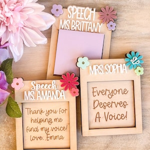 May include: Three wooden frames with floral accents. The frames have the text "Speech Ms. Brittany", "Speech Ms. Amanda", and "Mrs. Sophia". The frame for Ms. Amanda says "Thank you for helping me find my voice! love, Emma". The frame for Mrs. Sophia says "Everyone Deserves A Voice!"