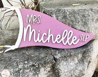 May include: Pink pennant banner with white text that reads "Mrs. Michelle SLP".