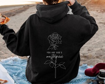 May include: Black hooded sweatshirt with a white line drawing of a rose and the text "You are God's masterpiece".