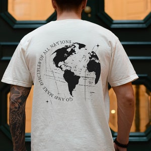 May include: A white t-shirt with a black graphic print of a globe with the text "GO AND MAKE DISCIPLES OF ALL NATIONS" on the back.