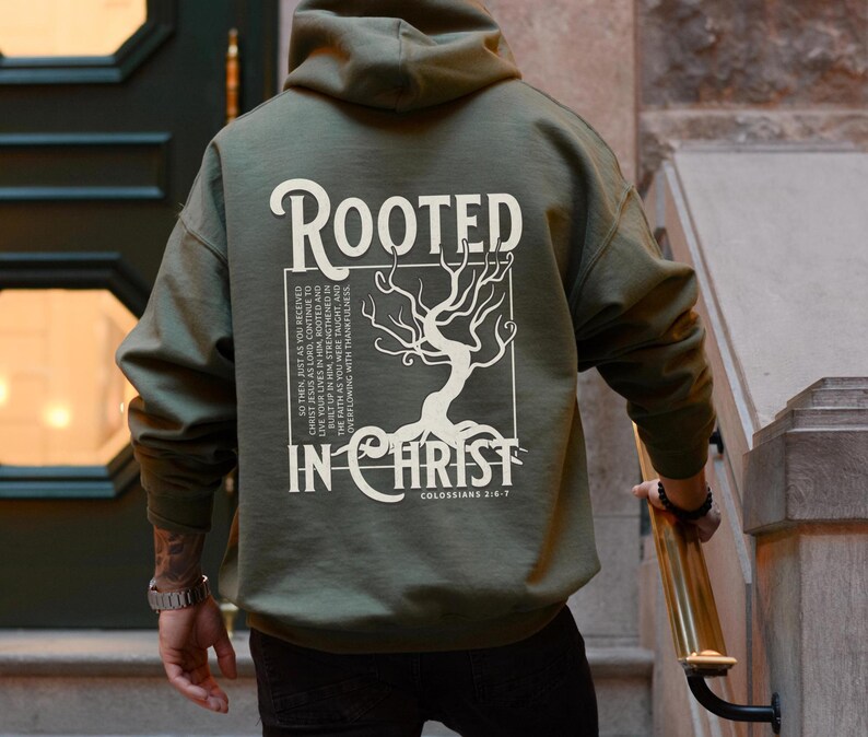 May include: A green hooded sweatshirt with a white graphic print of a tree with roots and the text "Rooted in Christ" and "Colossians 2:6-7".