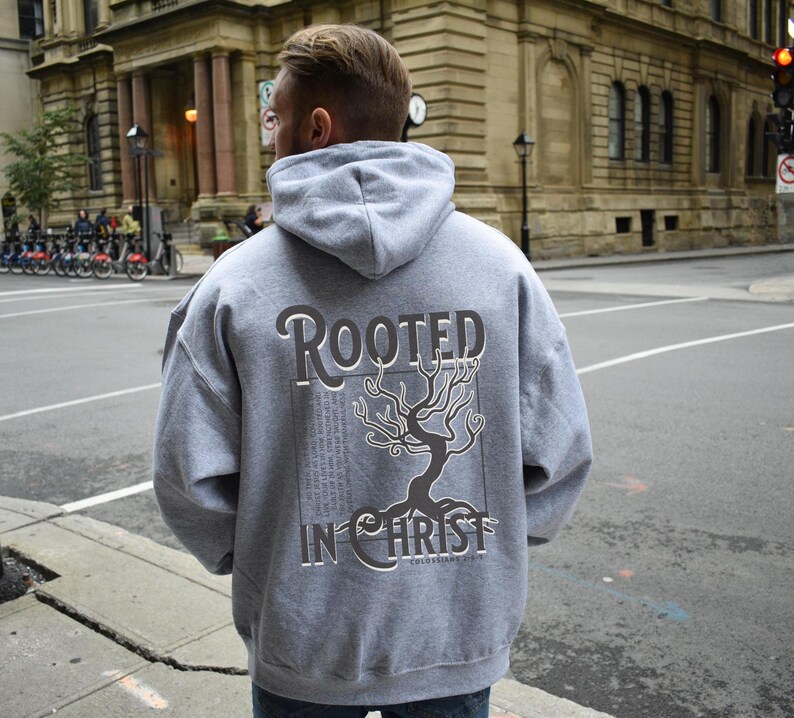 May include: Grey hooded sweatshirt with a black tree graphic and the text "Rooted in Christ" on the back.
