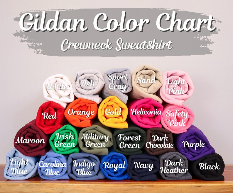 May include: A colour chart for Gildan crewneck sweatshirts. The image shows rolled fabric samples in various colours, including white, red, orange, gold, and black. Each colour is labelled with its name.
