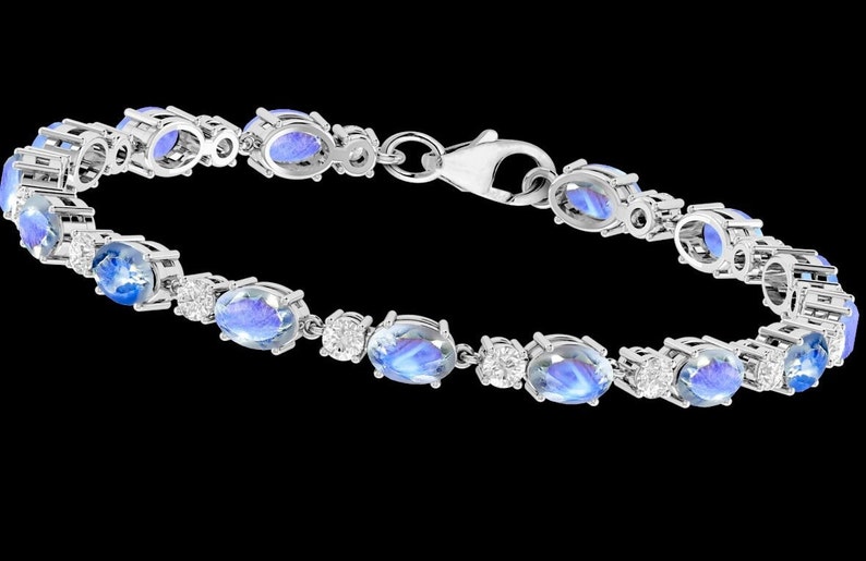 Puede incluir: Un brazalete de plata con piedras azules ovaladas y piedras transparentes redondas m&aacute;s peque&ntilde;as.