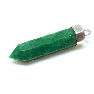 May include: A green gemstone pendant with a silver cap and a loop for attaching a chain. The gemstone is a long, pointed shape.