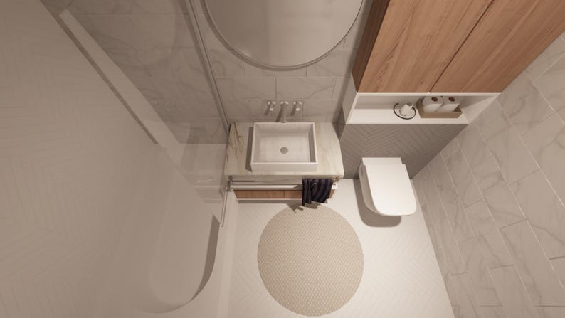 Peut inclure: Vue a&eacute;rienne d'une salle de bain moderne avec des toilettes, un lavabo et un meuble en bois blancs. Un tapis rond beige est pos&eacute; sur le sol. Les murs sont carrel&eacute;s dans un motif gris clair.