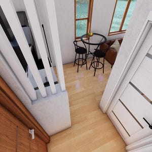 May include: Interior view of a modern home with a wooden door, white walls, and a small dining area. The dining area features a round table and two black bar stools. A white door with horizontal glass panels is visible.