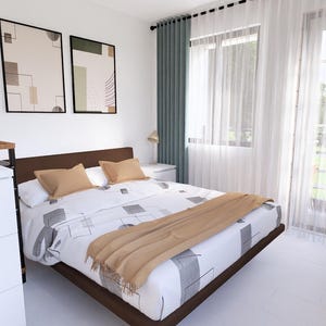 May include: A contemporary bedroom scene featuring a bed, chest of drawers, and framed art. The bed has a brown frame, patterned bedding, and tan pillows and a throw. Two abstract art prints hang above the bed. A white chest of drawers with black handles is on the left.